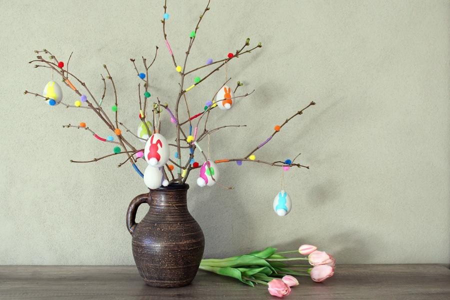 Creating a colorful Easter branch with pom-poms