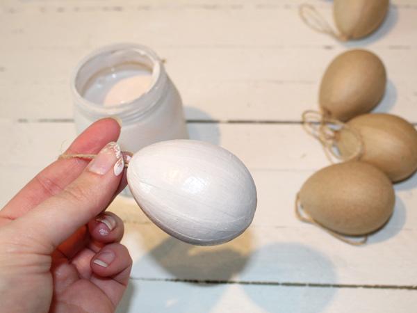 Priming Easter eggs with white paint