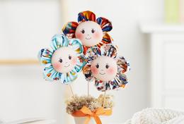 Fabric flowers with face in a pot